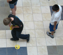 3 students using tile floor as a coordinate grid.